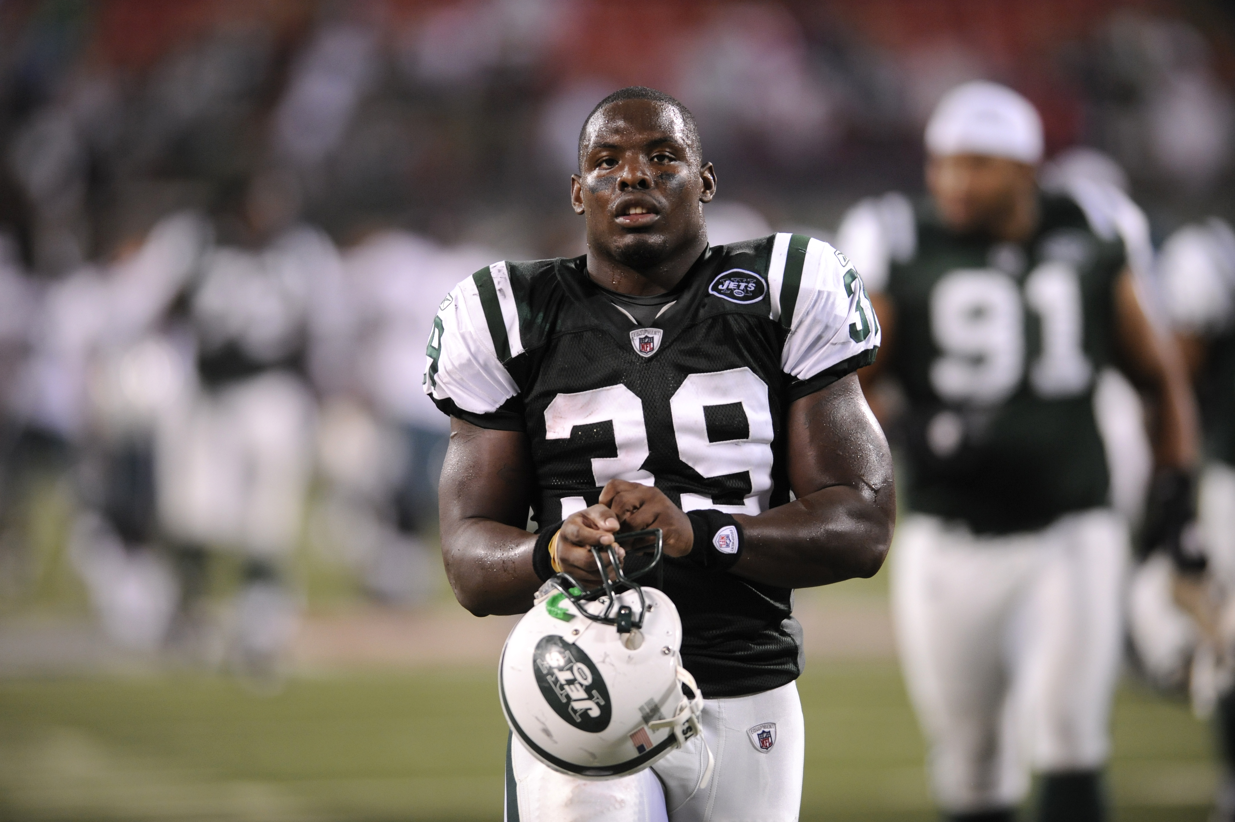 Jehuu Caulcrick #39 in a New York Jets uniform on the sideline